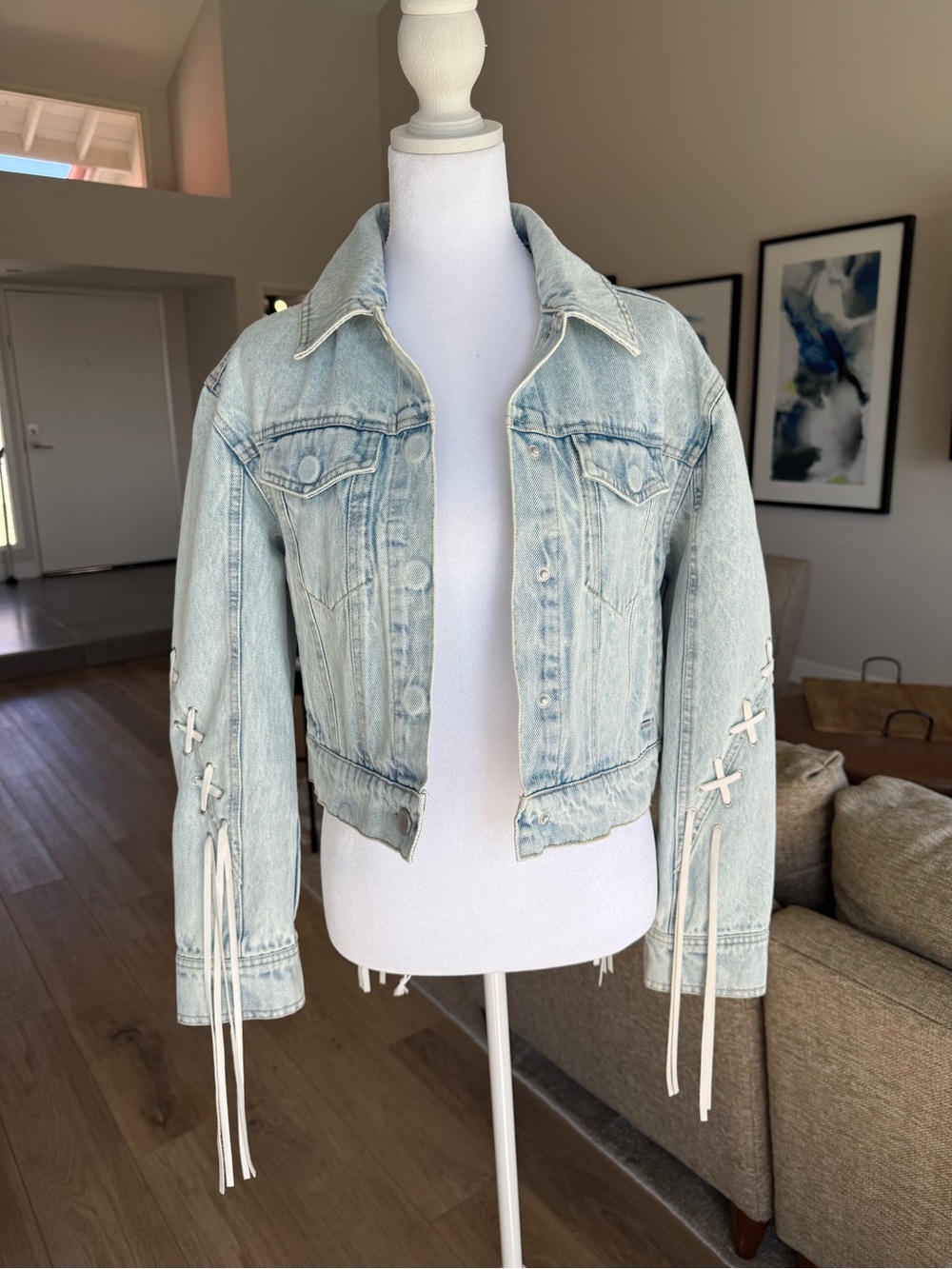 Blank NYC Faded Light Blue Cropped Denim Jacket with Fringe Lace-Up Sleeves